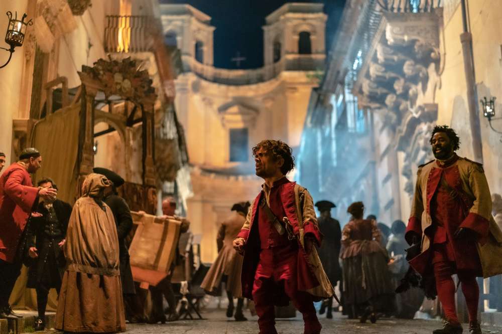 C_06888_RCPeter Dinklage stars as Cyrano and Bashir Salahuddin as Le Bret in Joe Wright’sCYRANOA Metro Goldwyn Mayer Pictures filmPhoto credit: Peter Mountain© 2021 Metro-Goldwyn-Mayer Pictures Inc. ...